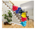 Colorful balloon garland in a home setting, featuring red, blue, yellow, and black balloons with professional-quality decor.