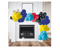 Colorful balloon garland decoration in blue, yellow, red, and black over a fireplace, showcasing versatile event decor.